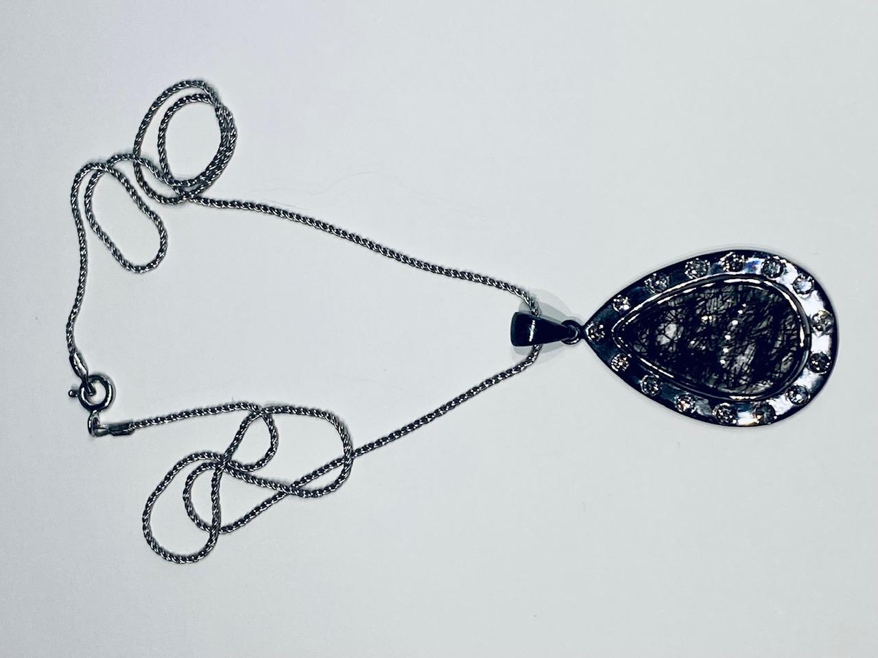 A Darkened Silver Pendant set with Diamonds,  around a Grafetite Quartz Cabochon For Sale 1