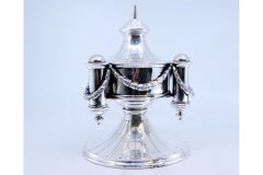 Silver perfume bottle with round base and cord application around the edge