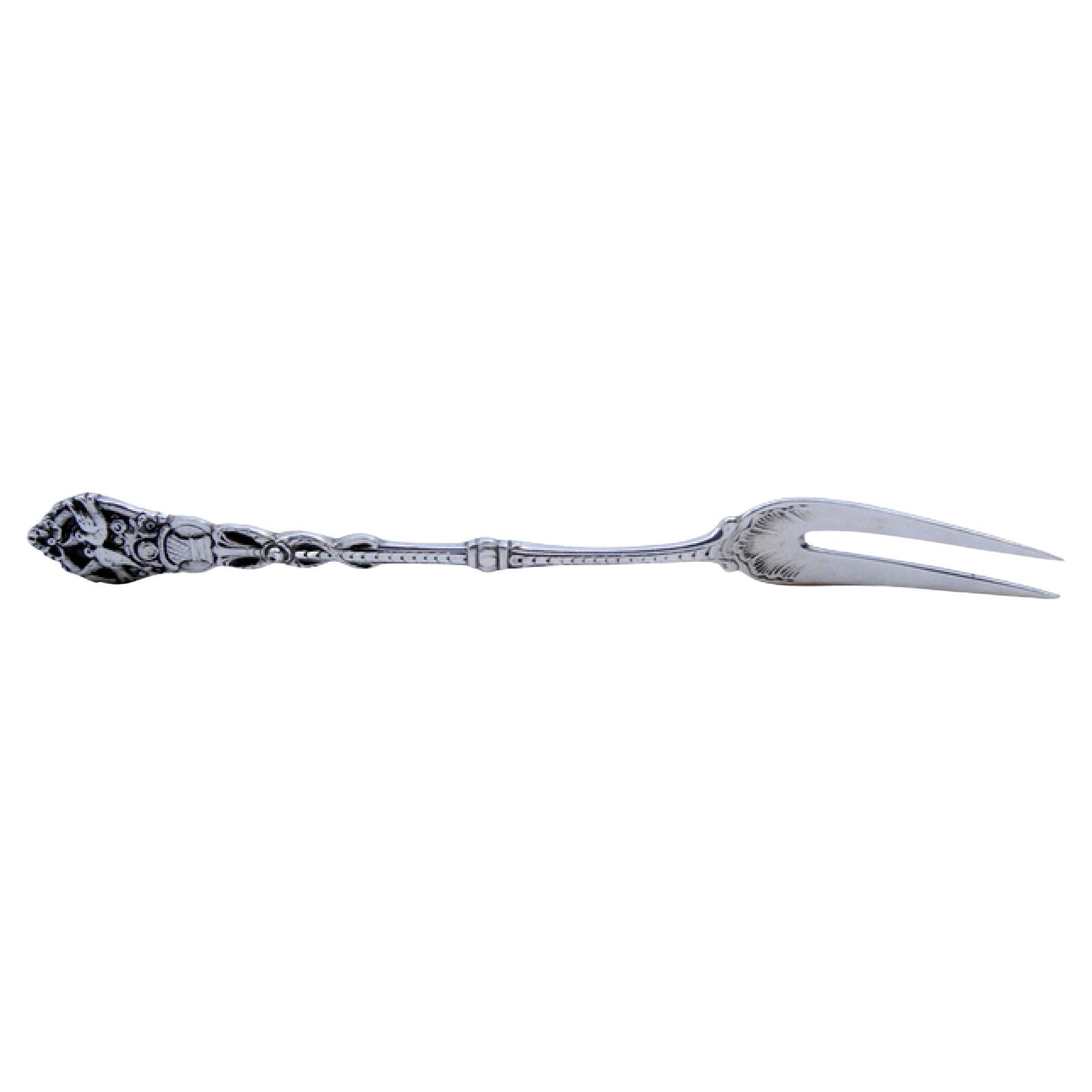 Silver pickle fork with two prongs and bird-decorated raised handle