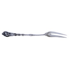 Silver pickle fork with two prongs and bird-decorated raised handle