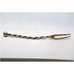 Silver pickle serving fork with two prongs and twisted handle