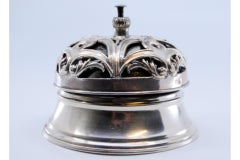 Silver pierced bell with floral reliefs and internal mechanism