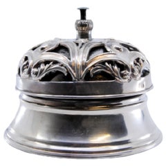 Silver pierced bell with floral reliefs and internal mechanism