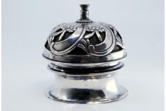 Silver pierced bell with spiral floral motifs and interior mechanism