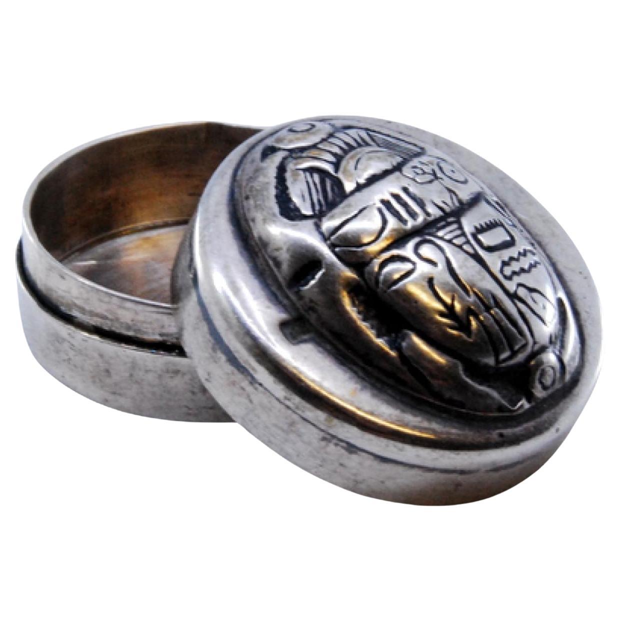 Silver pill box with African motifs on the removable lid