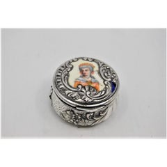 Silver pill box with antique lady figure in enamel on the hinged lid