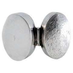 Silver pill box with elliptical shape and hinged lid
