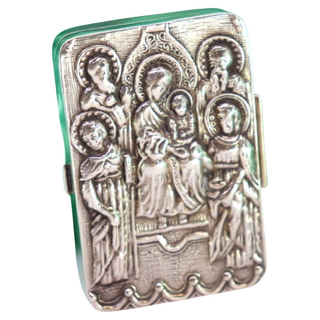 Silver pill box with embossed figures revealed on the lid