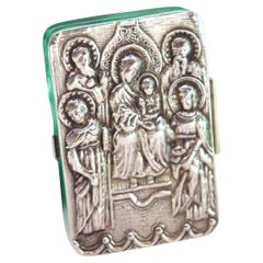 Silver pill box with embossed figures revealed on the lid