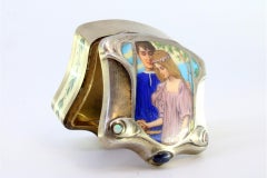 Silver pill box with engraved ivory couple scene and gold interior