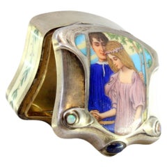 Silver pill box with engraved ivory couple scene and gold interior