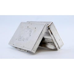 Silver pill box with engravings and trim on the hinged lid