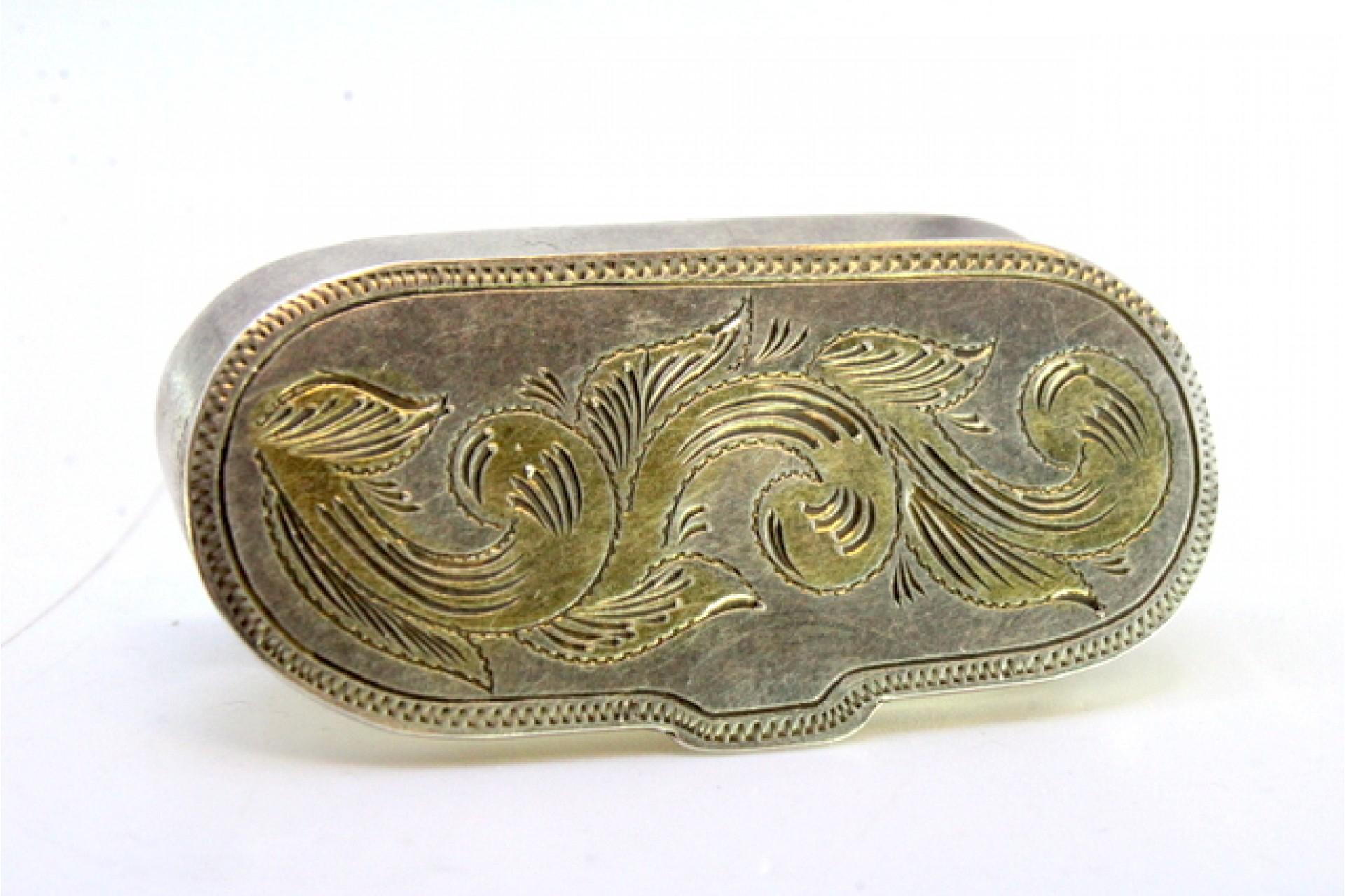Description: Silver pill box with floral motifs engraved on the hinged lid. Metal: Silver. Origin: Portuguese. Brand: Eagle Head. Weight: 20.75 grams. Dimensions: 5.2cmx2.5cm. Content: 835/1000. Assay Mark: Yes, between 1938 and 1984. Additional