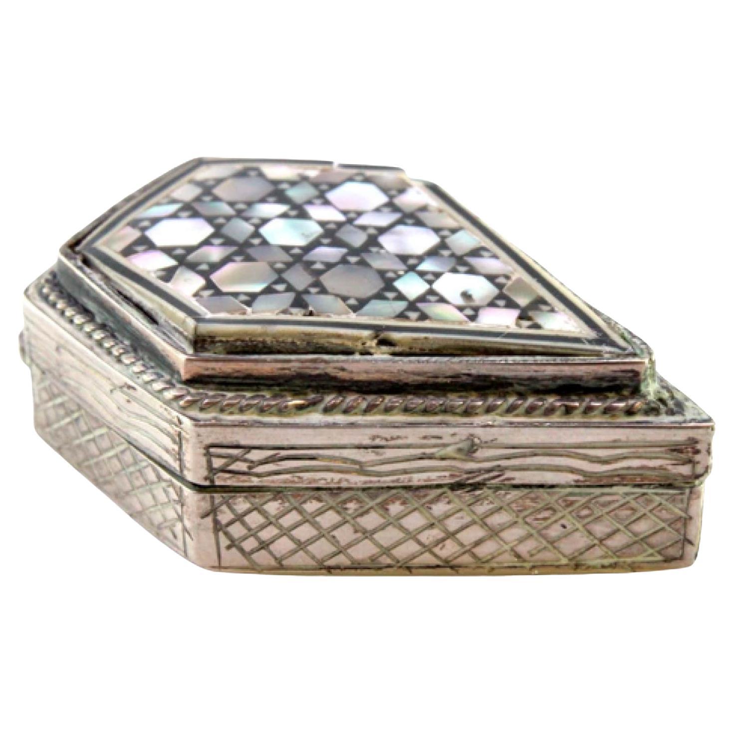 Silver pill box with mother of pearl on the lid and engraving on the casing
