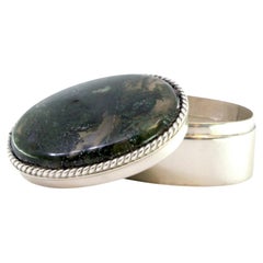 Silver pill box with pearl trim and lid with oval-shaped green stone