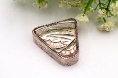 Silver pill box with triangular reliefs