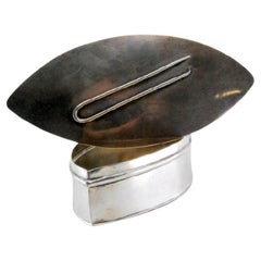 Silver pin box with raised pin design on the lid