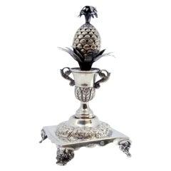 Silver pineapple-shaped toothpick holder on square base with four feet