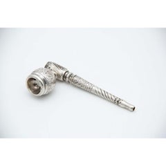 Silver pipe with raised plant motifs