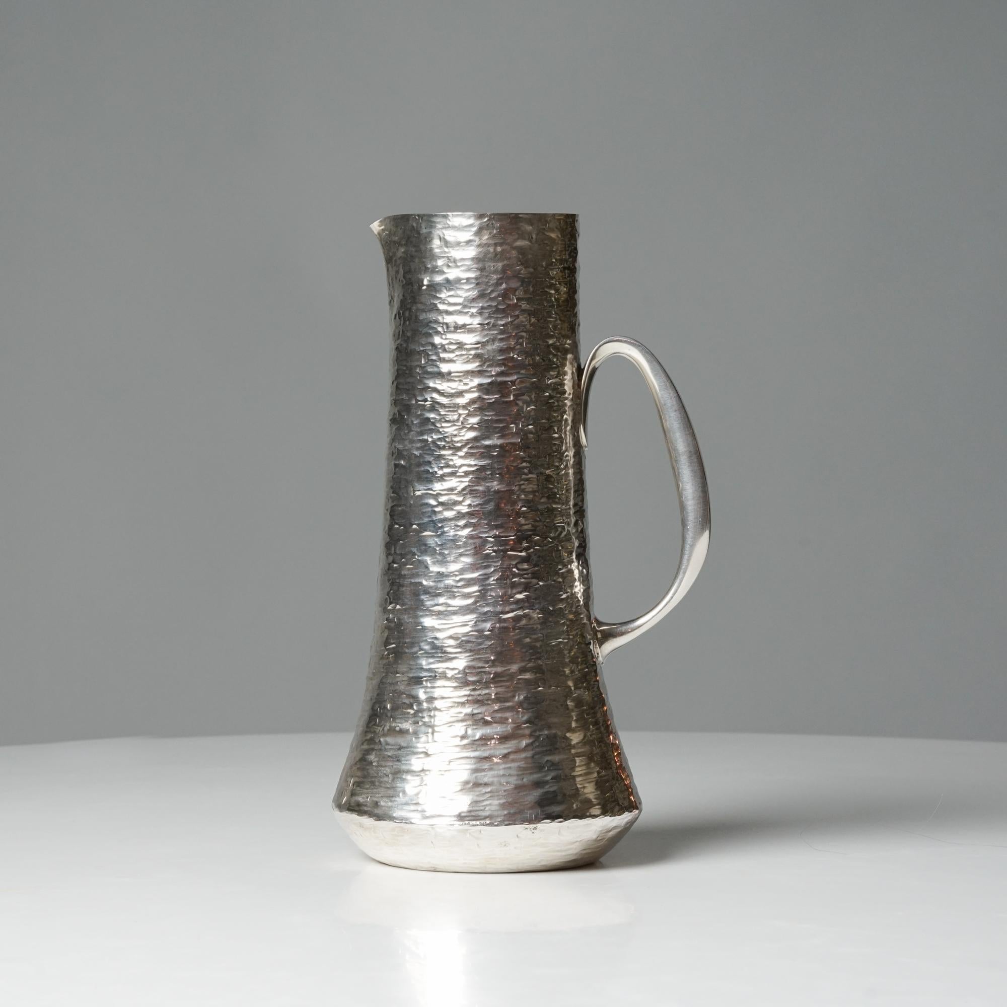 Silver pitcher, designed by Tapio Wirkkala, manufactured by Kultakeskus Oy, 1970s. Hand-forged silver. Marked and signed. Good vintage condition, minor patina and wear consistent with age and use. 