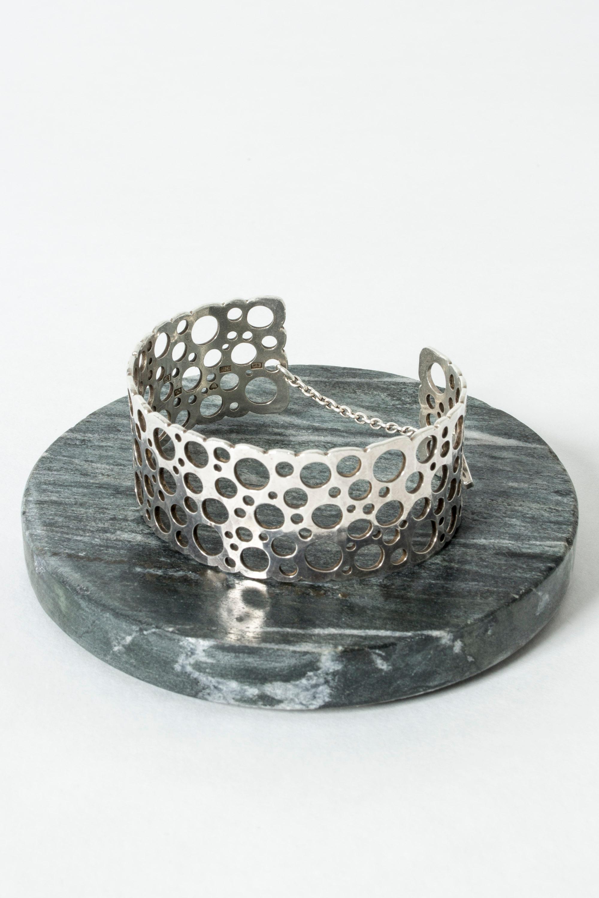 Amazing silver bracelet by Liisa Vitali, in a design called “Pitsi”, which means lace. Airy, playful design that looks great on the arm. Neat security chain on the back.