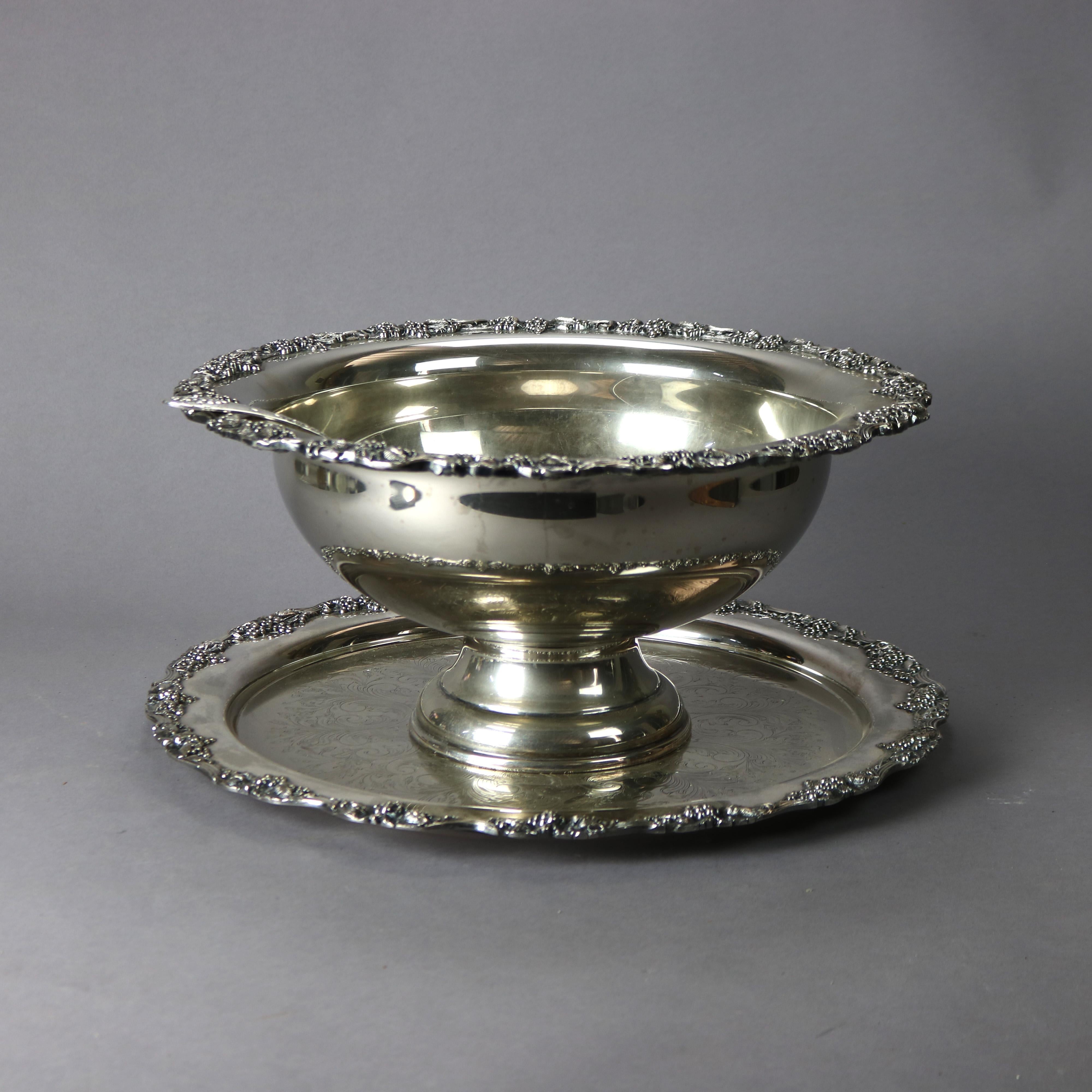 A silver plate punch bowl set by Sheriden Taunton Silversmiths offers silver plate construction with embossed and engraved foliate decoration; set includes tray, ladle and bowl; maker label as photographed; 20th century

Measures - Tray