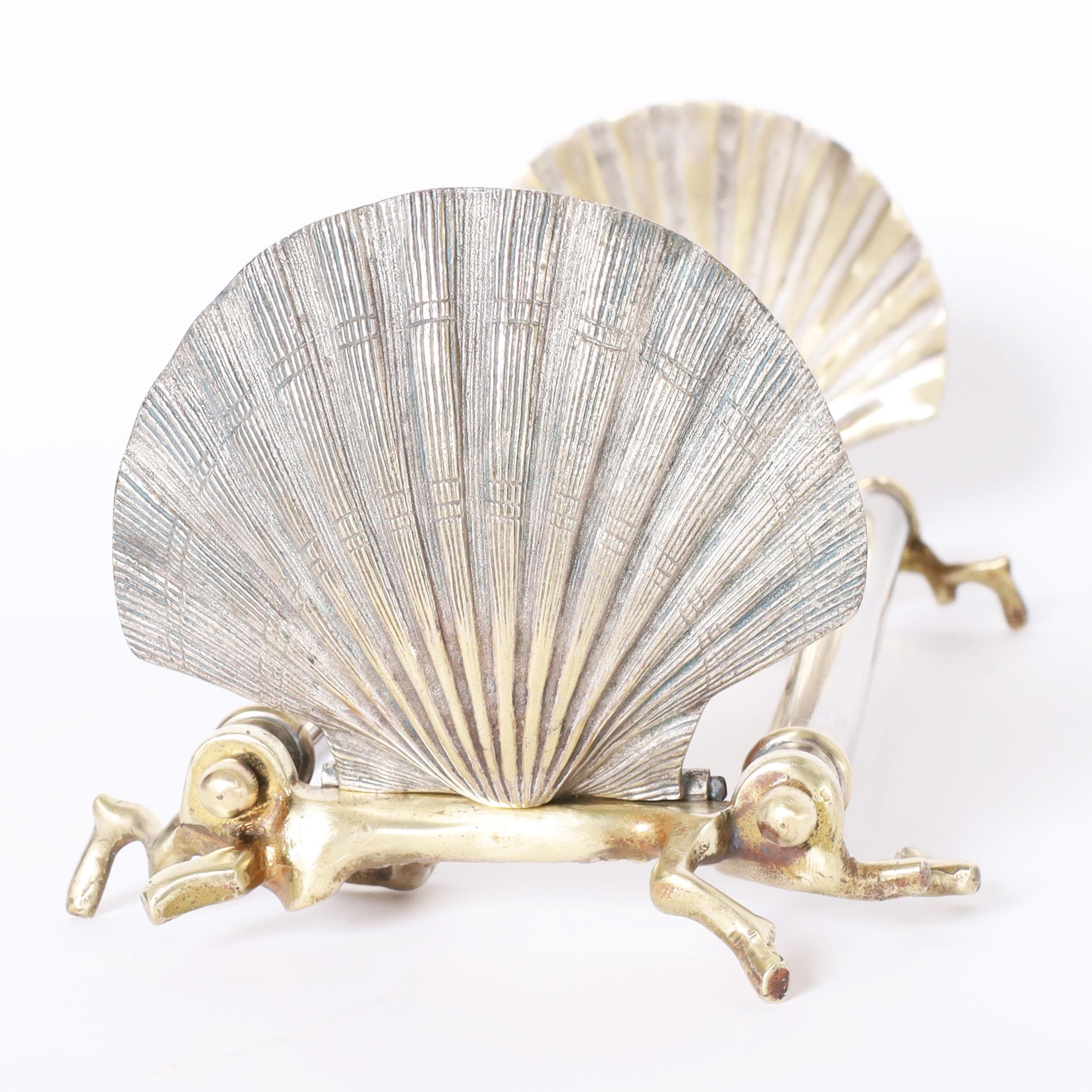 Unusual antique sea inspired bookends crafted with silver plate on brass rods and seashells at either end with faux coral brass feet.