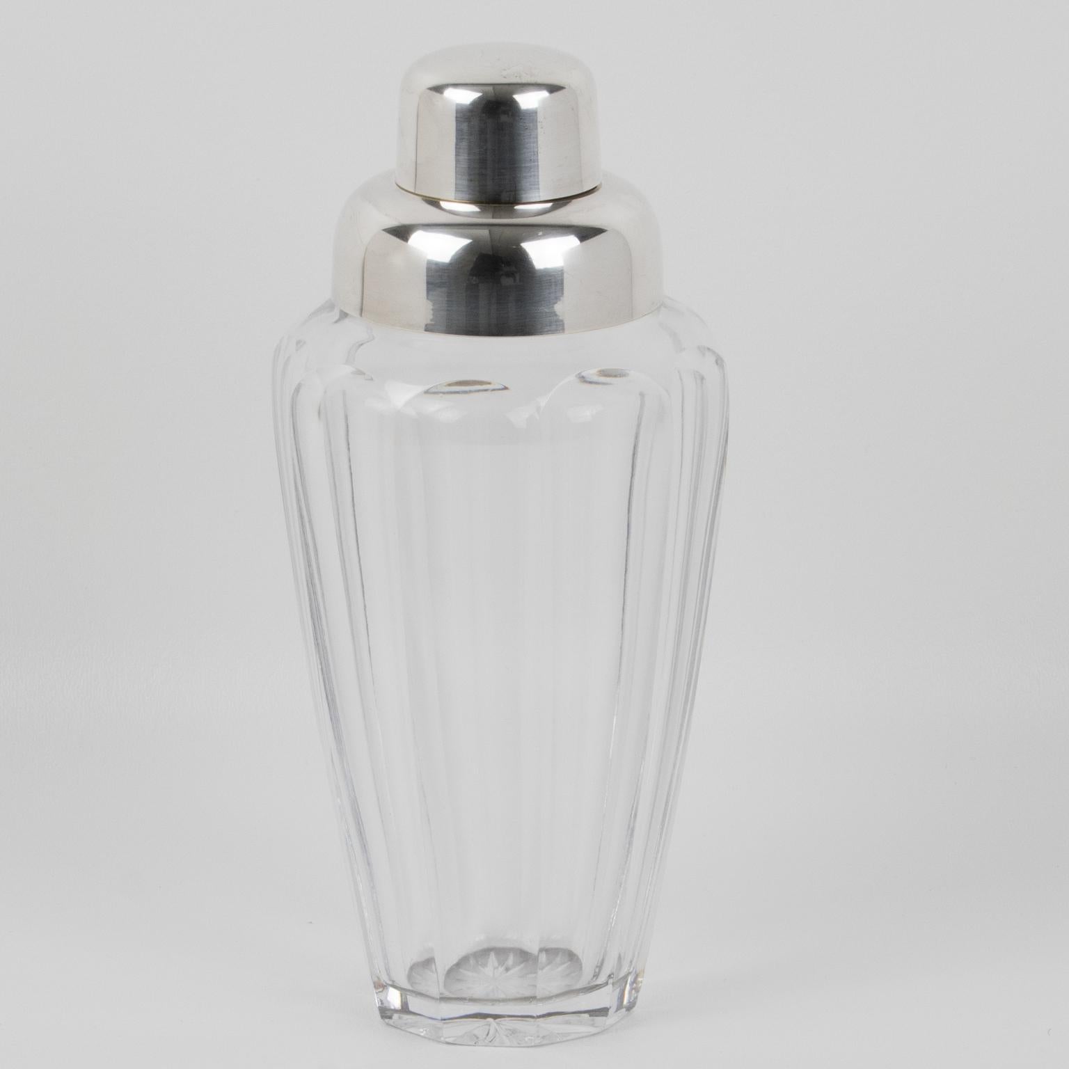 This exquisite mid-century silver-plated and crystal cocktail or Martini shaker was manufactured in Germany in the 1950s. It's a three-cylindrical sectioned design with a removable cap and strainer. The shaker boasts a beautifully carved cut crystal