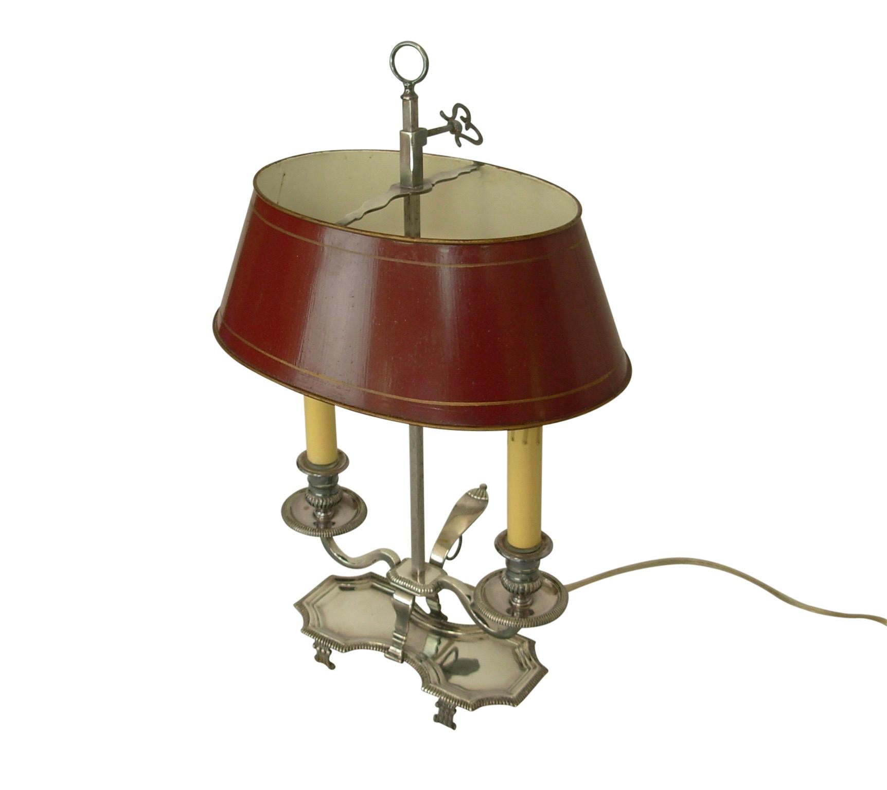 Silver plate Bouillotte table lamp with red tole painted shade. Holds two chandelier size light bulbs, recently re-wired, early 20th century.