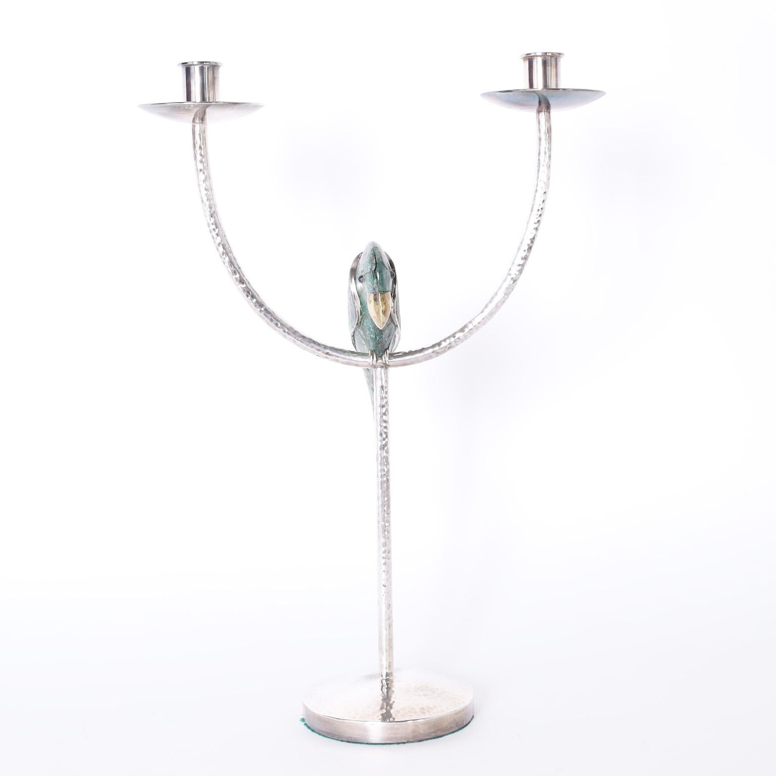 Enchanting two light candle stand hand crafted in silver plate over hammered copper featuring a stone clad bird or parrot. Signed Emilia Castillo 85 on the bottom.