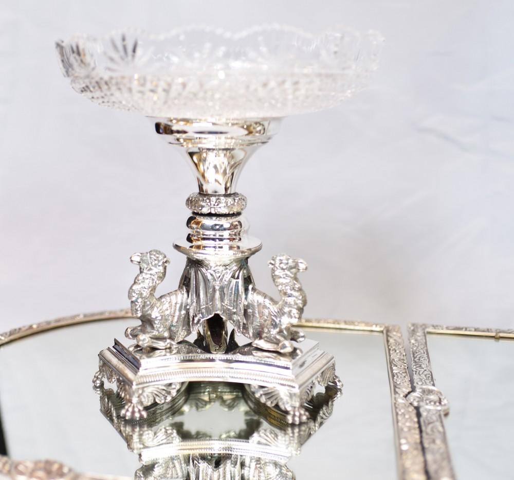 Wonderful Eklkington silver plate centrepiece or epergne
Comes on the five trays and features to side dishes, pair of vase flutes and the centre piece
Love the distinctive silver plate camels supporting each piece?
Impressive work designed for a