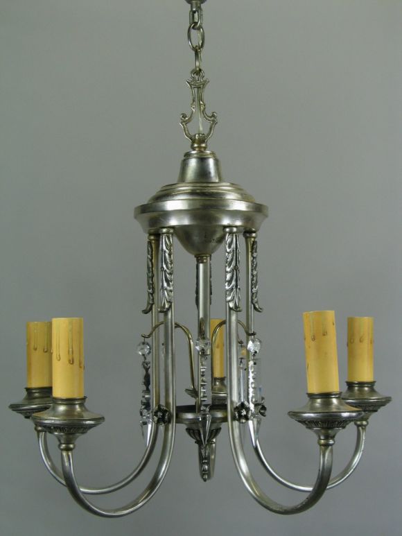 Five-light silver plate chandelier with center draped crystals.
   