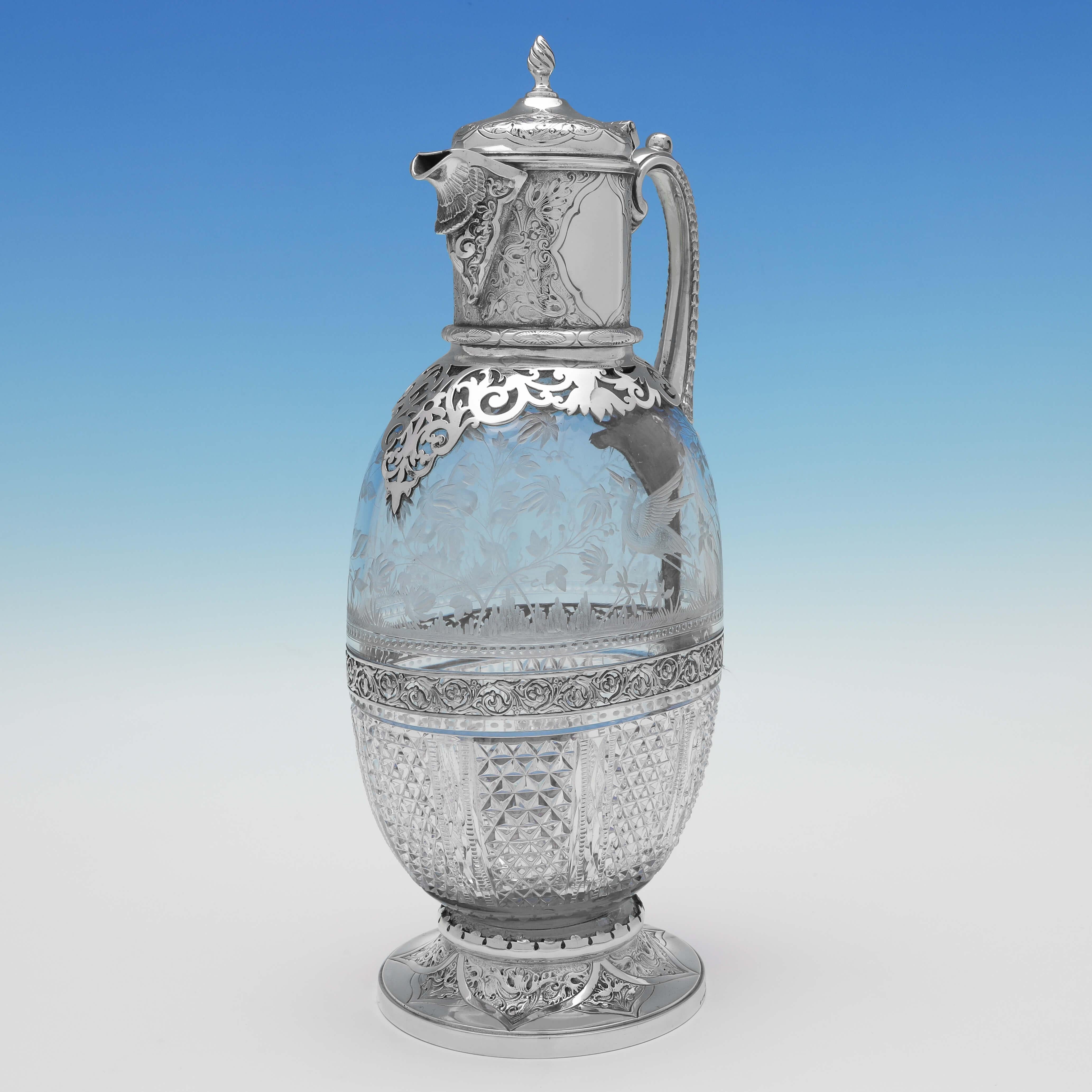 Carrying old plate marks for 1866 by Elkington & Co., this exceptional Victorian, antique silver plate claret jugantique silver plate claret jug, features a cut glass and etched glass body in the Aesthetic Movement taste, and an ornate silver plate