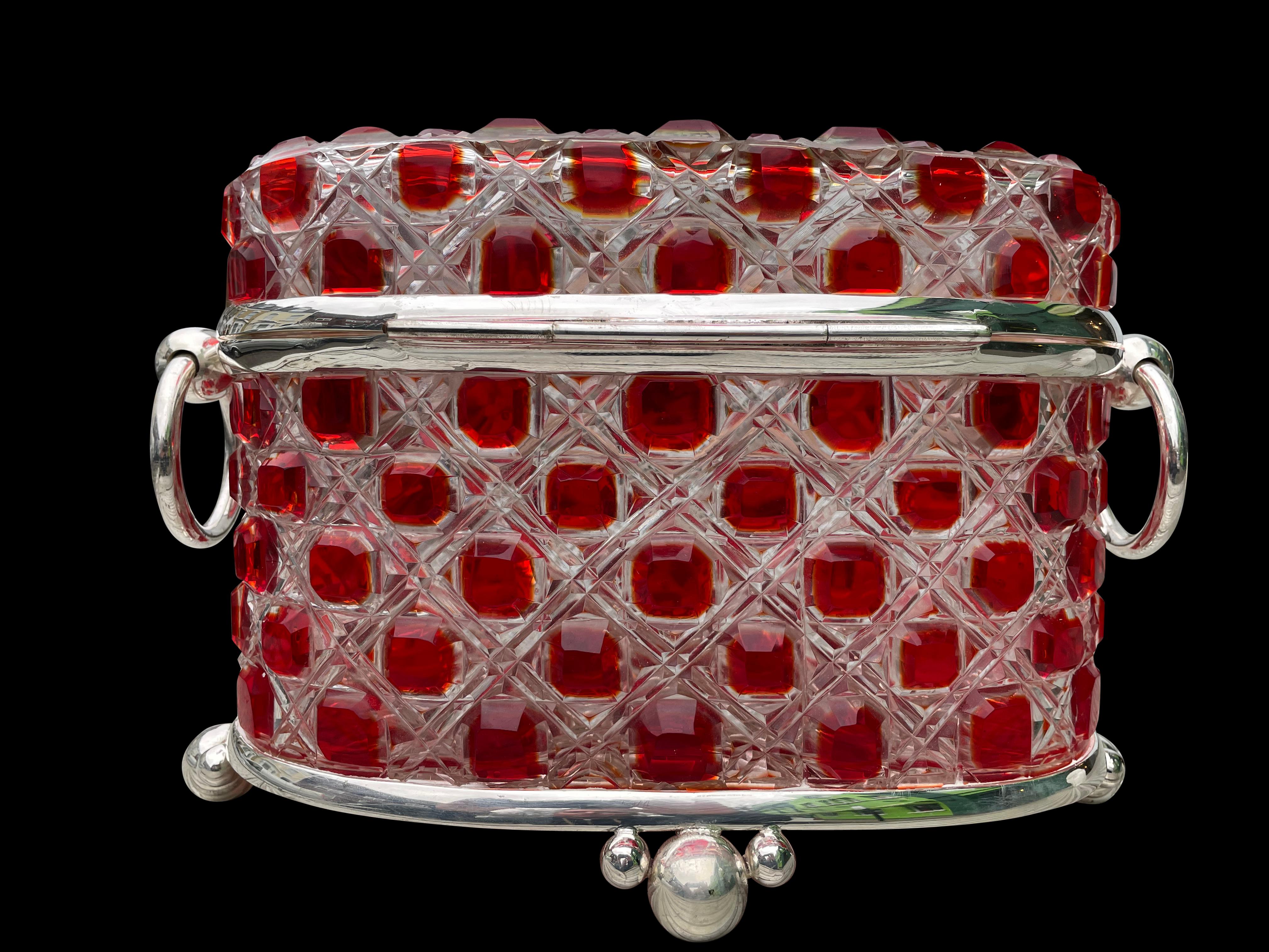 A stunning silver plate cut glass jewelry casket case box, 20th century. Love the intricately handcut glass with red designs. Silver plate has a lovely bright patina. Great collectors piece as well as a nice decorative item to display.