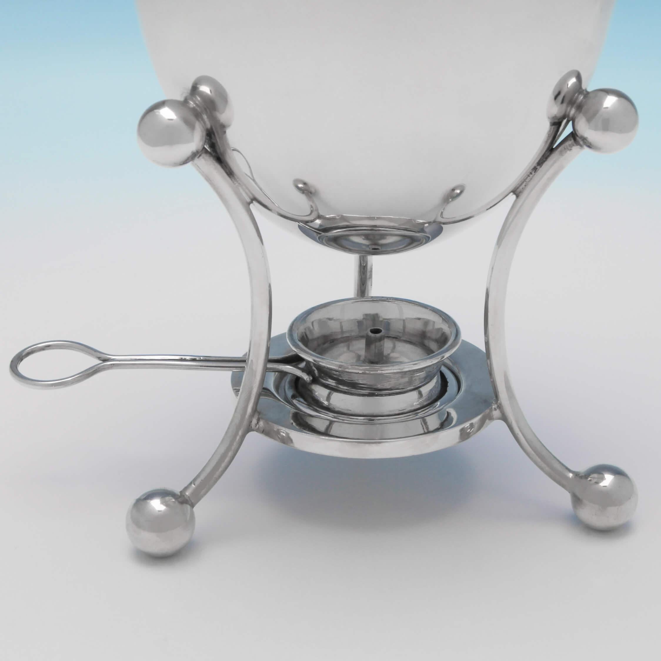 Made circa 1900 by Mappin & Webb and used to cook eggs at the table or on a picnic, this handsome, Edwardian, antique, silver plate egg coddler, has an egg shaped body with a lift off lid and wooden finial, supported by a frame with ball feet that