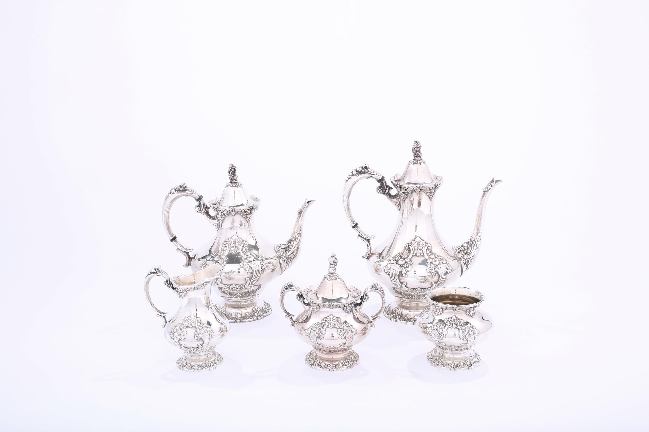 Silver plated five pieces tea and coffee service with exterior floral design details. Each piece is in great condition. Minor wear consistent with age / use. Maker's mark undersigned Reed & Barton 