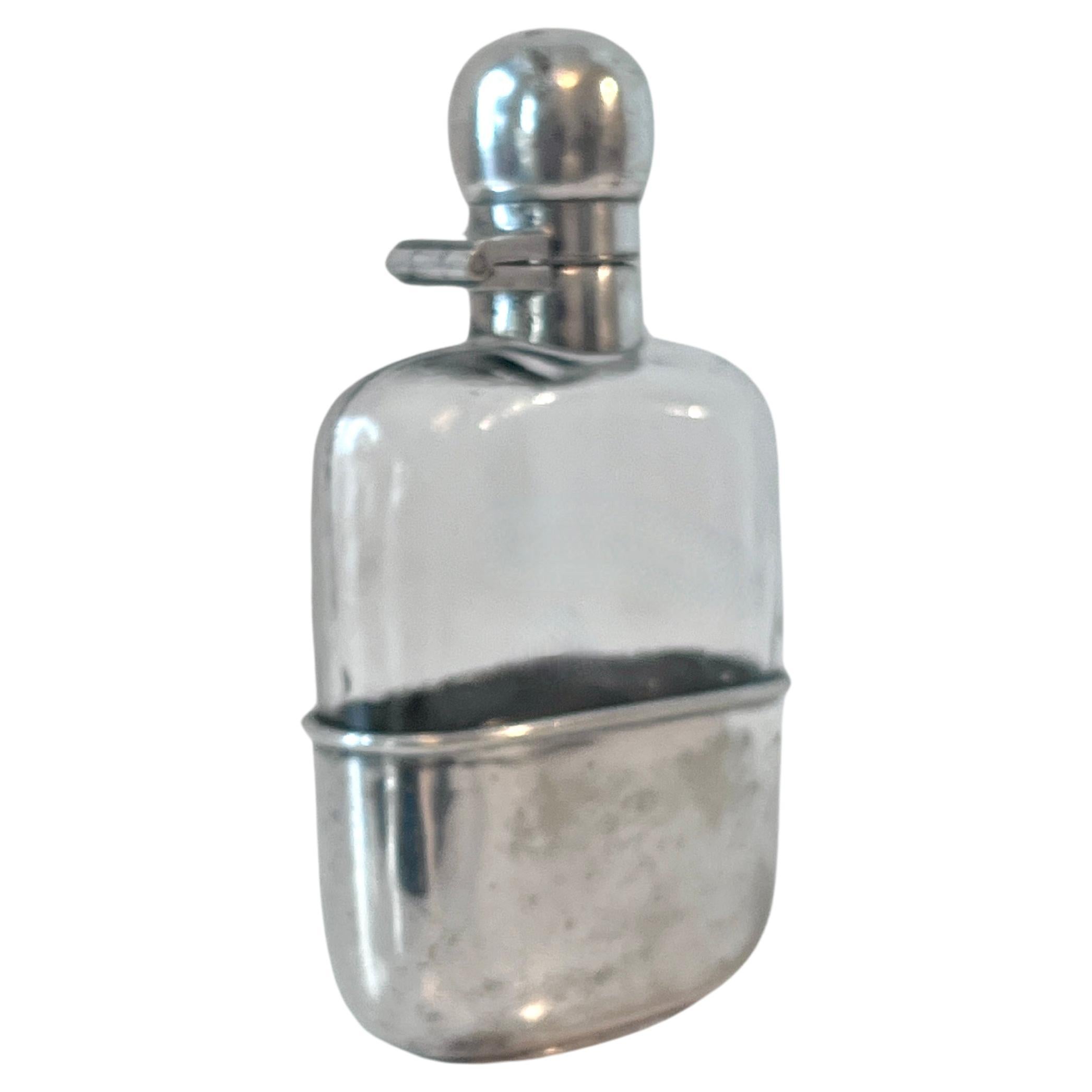 A wonderful Silver Plate Flask.  The top is a screw type closure and does not leak.

The Bottom slides off to be used as a cup.  A small flask that is a perfect fit for a side pocket, pant pocket or jacket and also works in a hand bag.

Take your