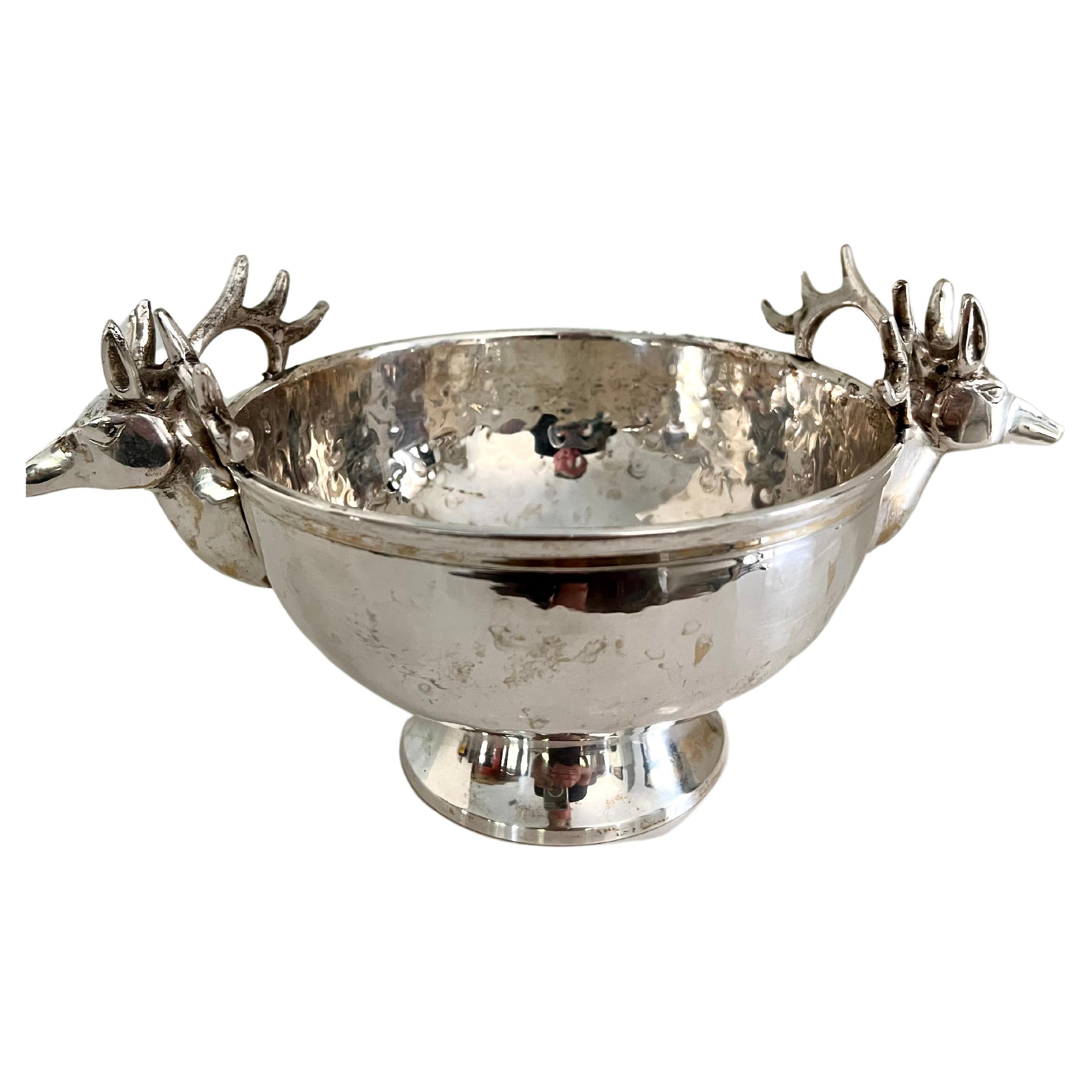 A lovely silver plate hammered bowl with Stags on either side. a compliment as a serving piece, especially for the holidays or in a cabin, or rustic setting. also works well as a floral vase or to throw ones keys into. multi purpose, solid and very