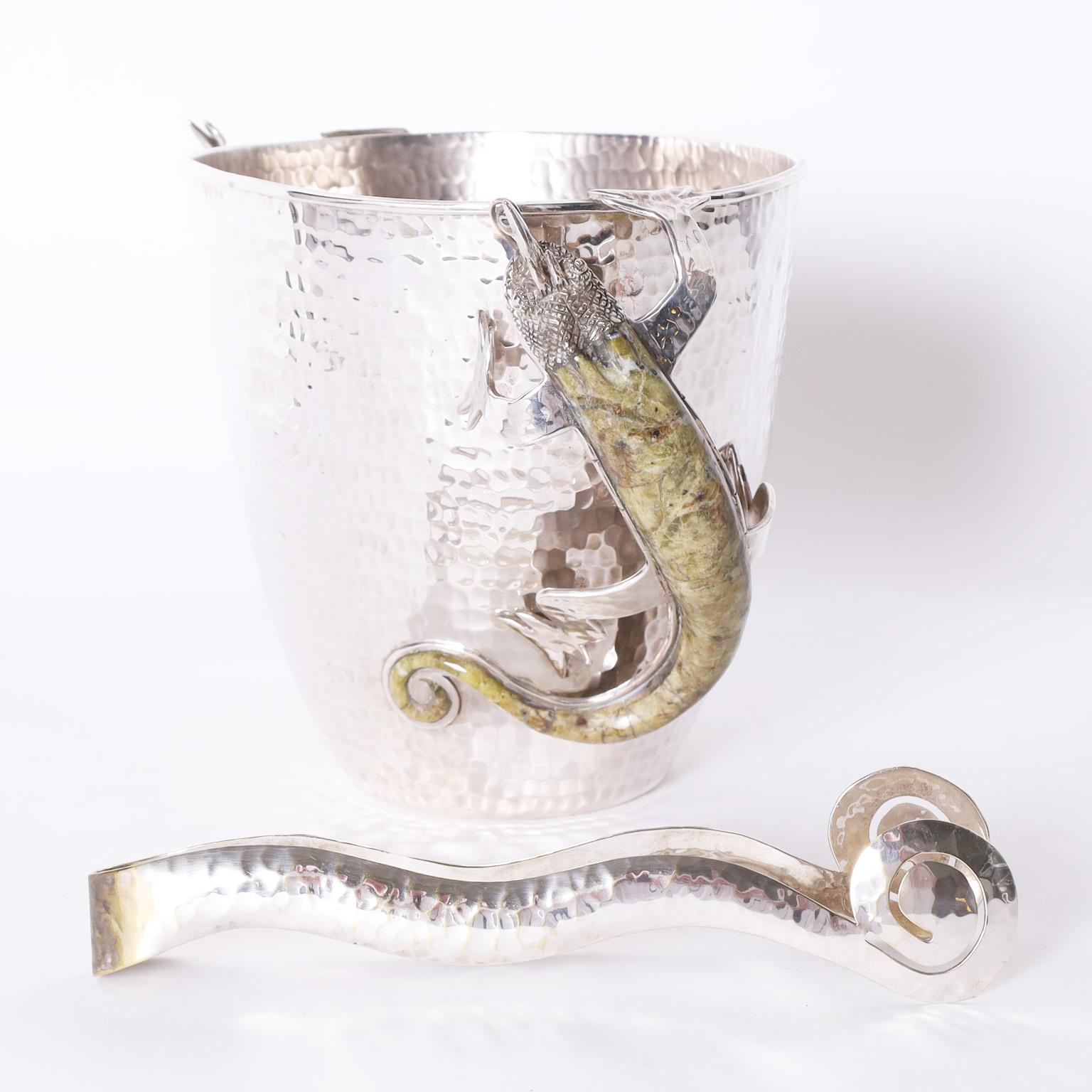 Standout modernist ice bucket and matching tongs crafted in silver plate on copper featuring stone clad lizard handles. Signed Wolmar Castillo Silversmiths on the bottom.