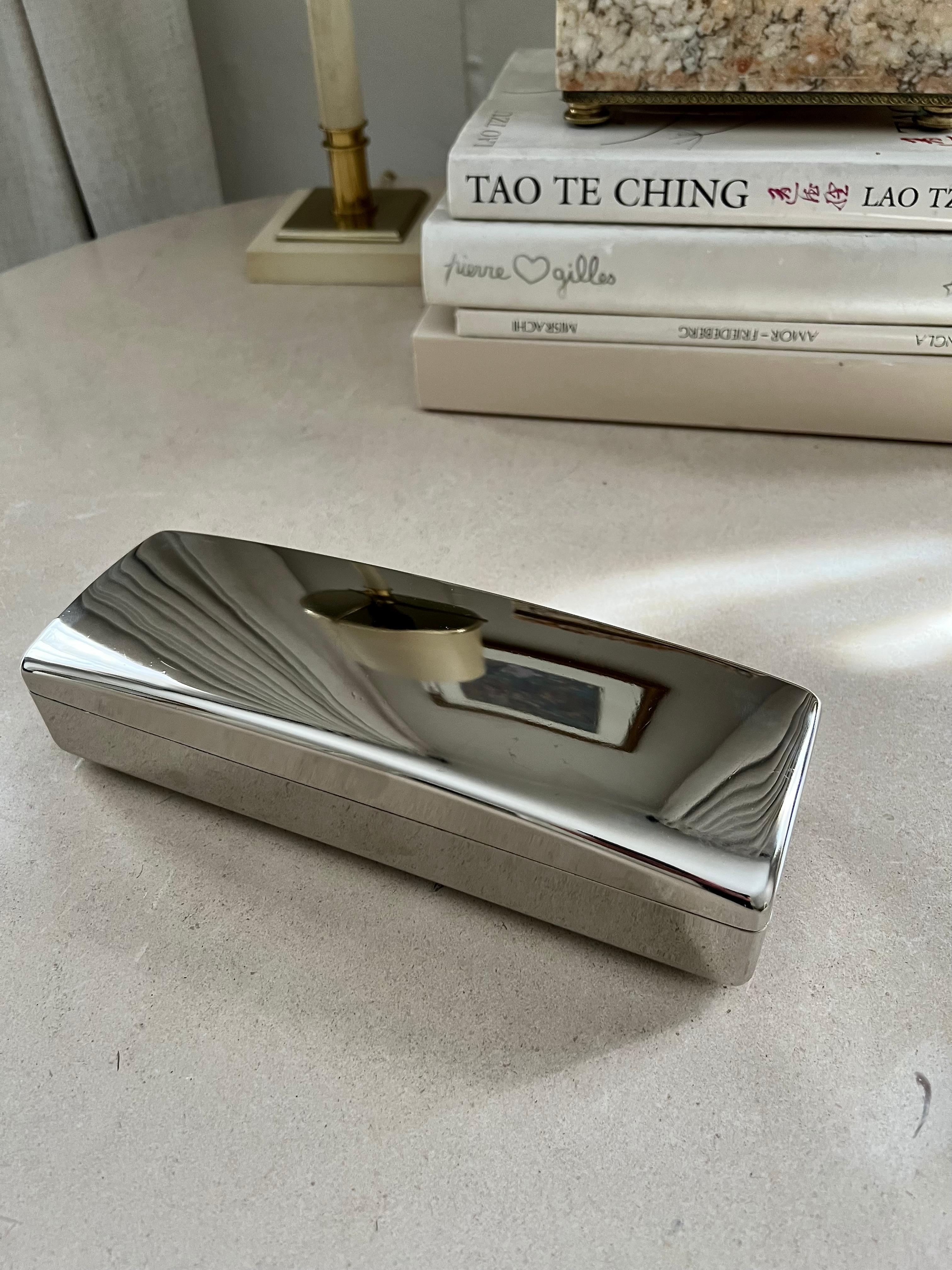 Silver box with three unlined compartments and hinged lid. Felt pads on the bottom to protect surfaces. Recently polished. Opens and closes smoothly. A complement to any vanity or dresser. A wonderful place for jewelry, hair accessories, mementos or