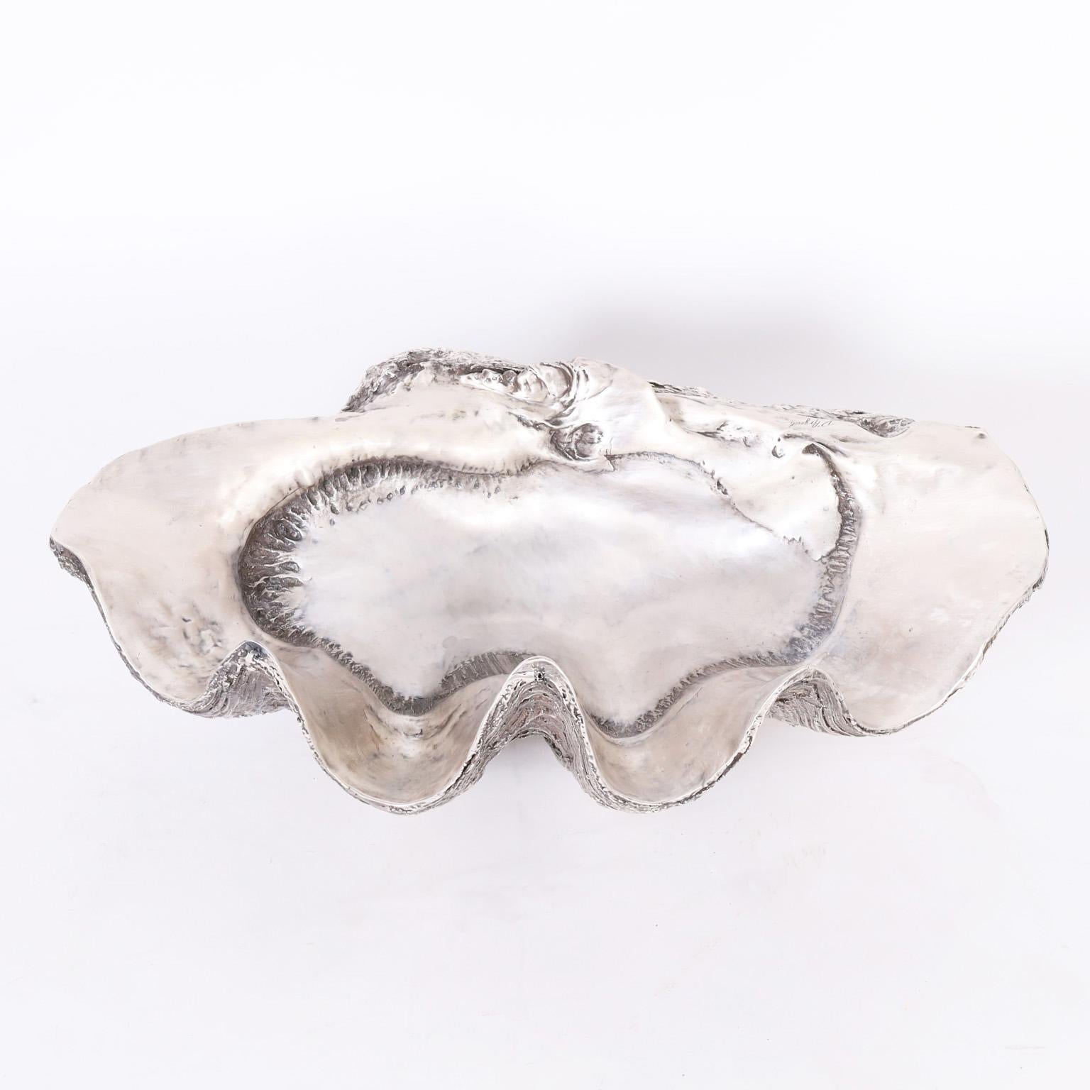 Striking life size giant clam shell sculpture or object of art having the iconic form and texture with a silver plated finish by D'Argenta Studios.