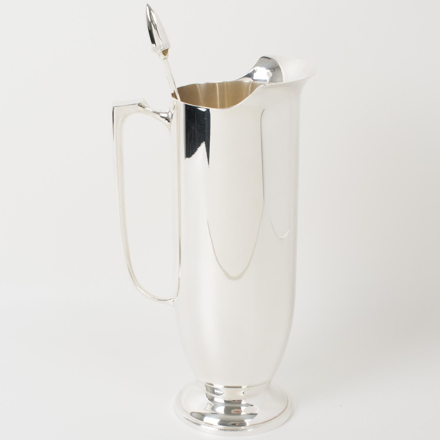 Elegant silver plate cocktail or Martini pitcher with stirrer by silversmith Towle for William Adams. Sleek and modernist shape with tall silver plate Martini pitcher or mixer jug and long stirrer spoon. Marked on the long spoon with legal