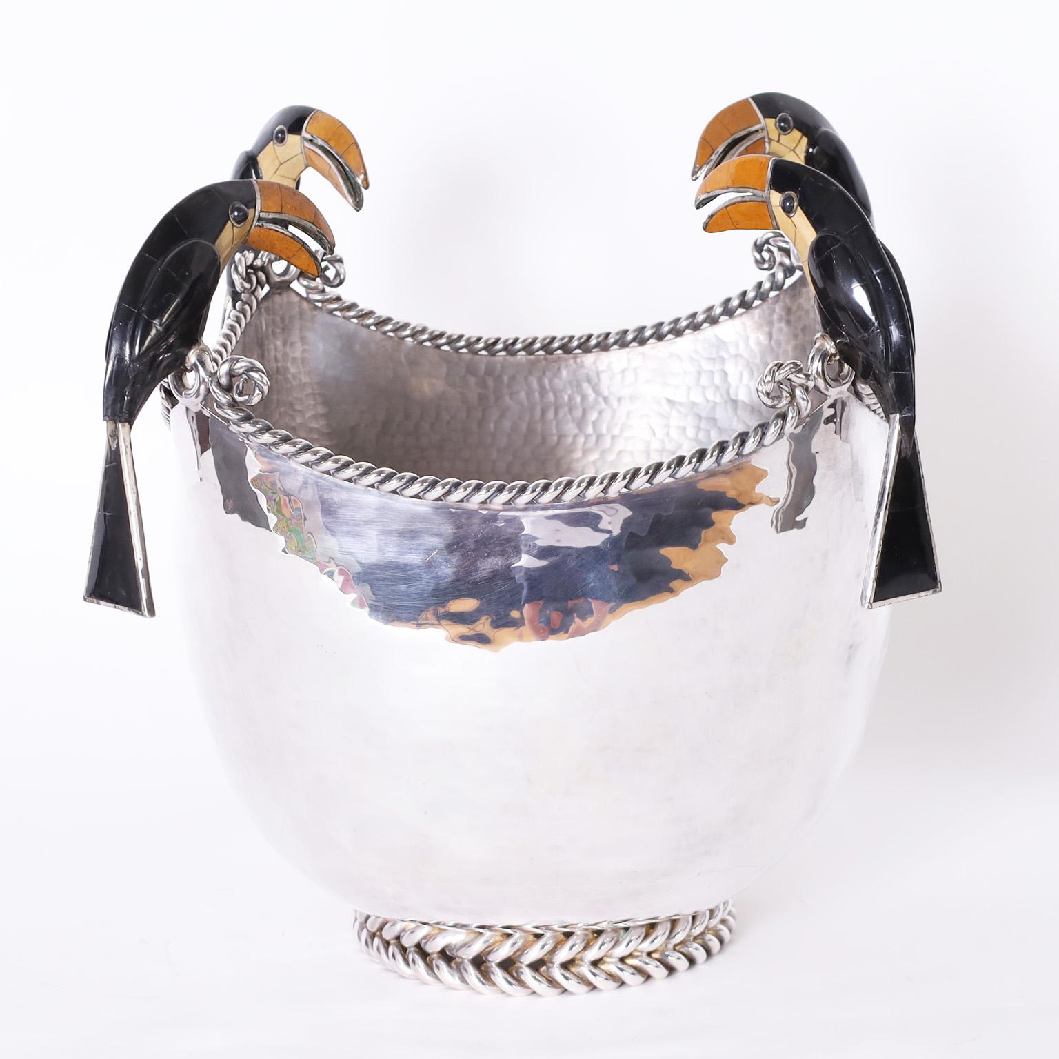 Lofty modernist bowl crafted in silver plate on copper featuring four stone clad toucans perched on the twisted metalwork lip and a jewelry like metalwork foot. Signed Emilia Castillo on the bottom.