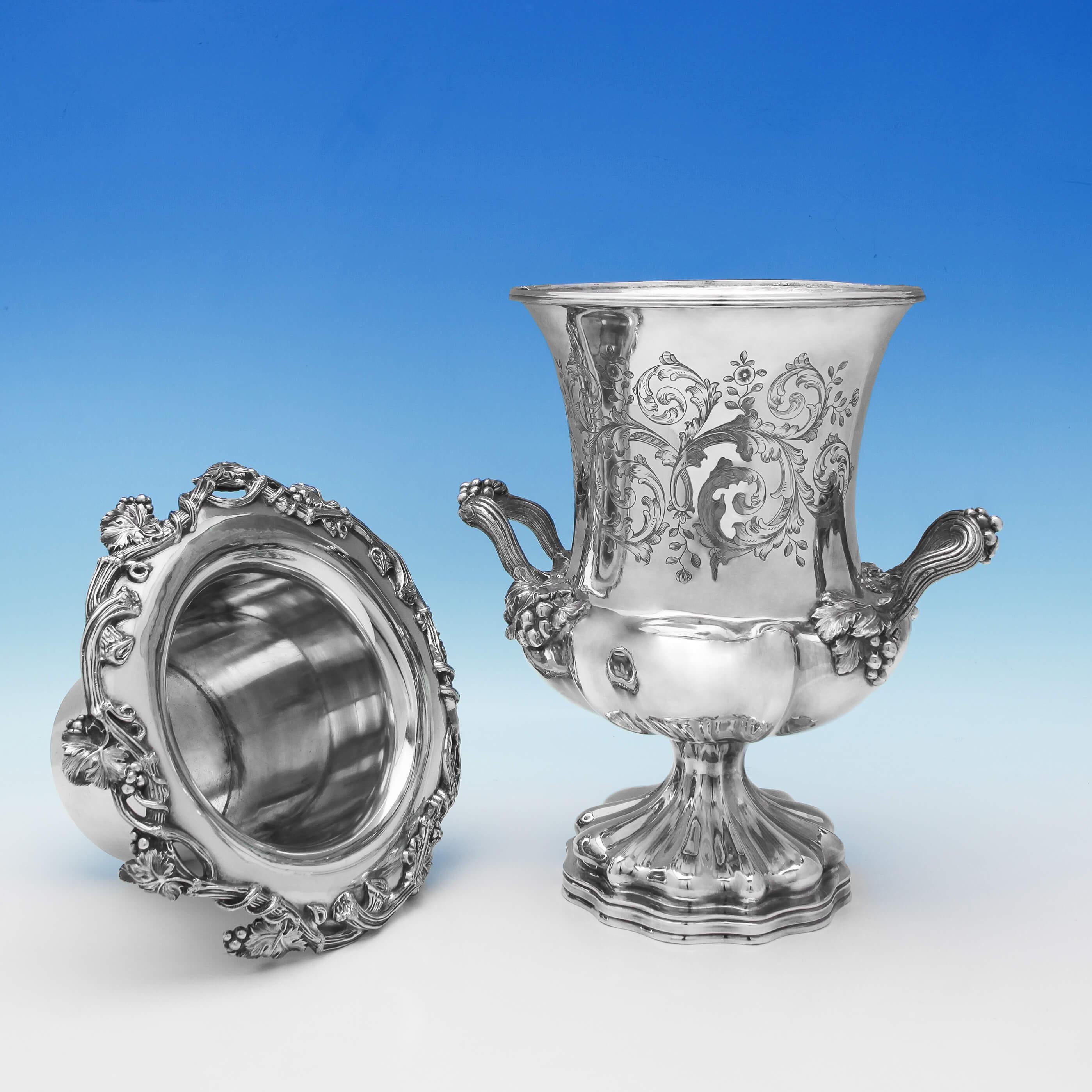 Made in 1845 by Elkington Mason & Co., this fantastic pair of antique, Victorian, silver plate wine coolers feature original crests, grape and vine decoration, acanthus handles and campana shape bodies with floral and scroll engraving. They have