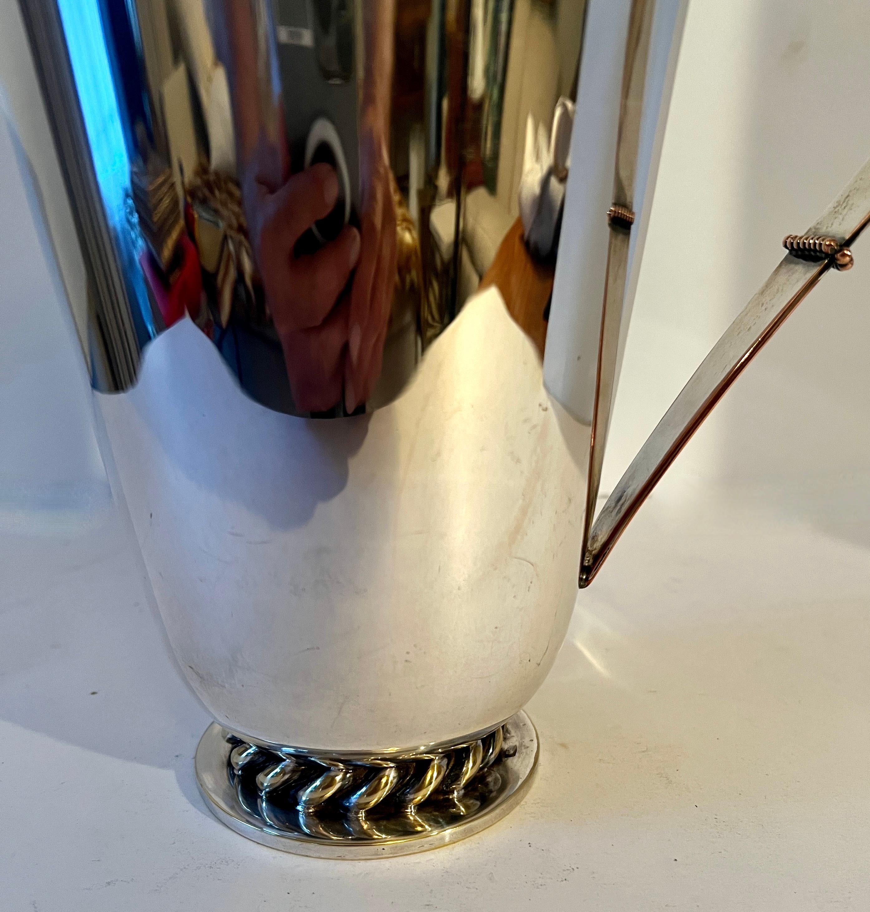 A very sexy and sophisticated Silver Plate Pitcher.  The shape and styling are impeccable.  A nice sized pitcher for mixers, cocktails, juices, etc.

The star of any well stocked bar, the shape is great and the handle has a Georg Jensen inspired