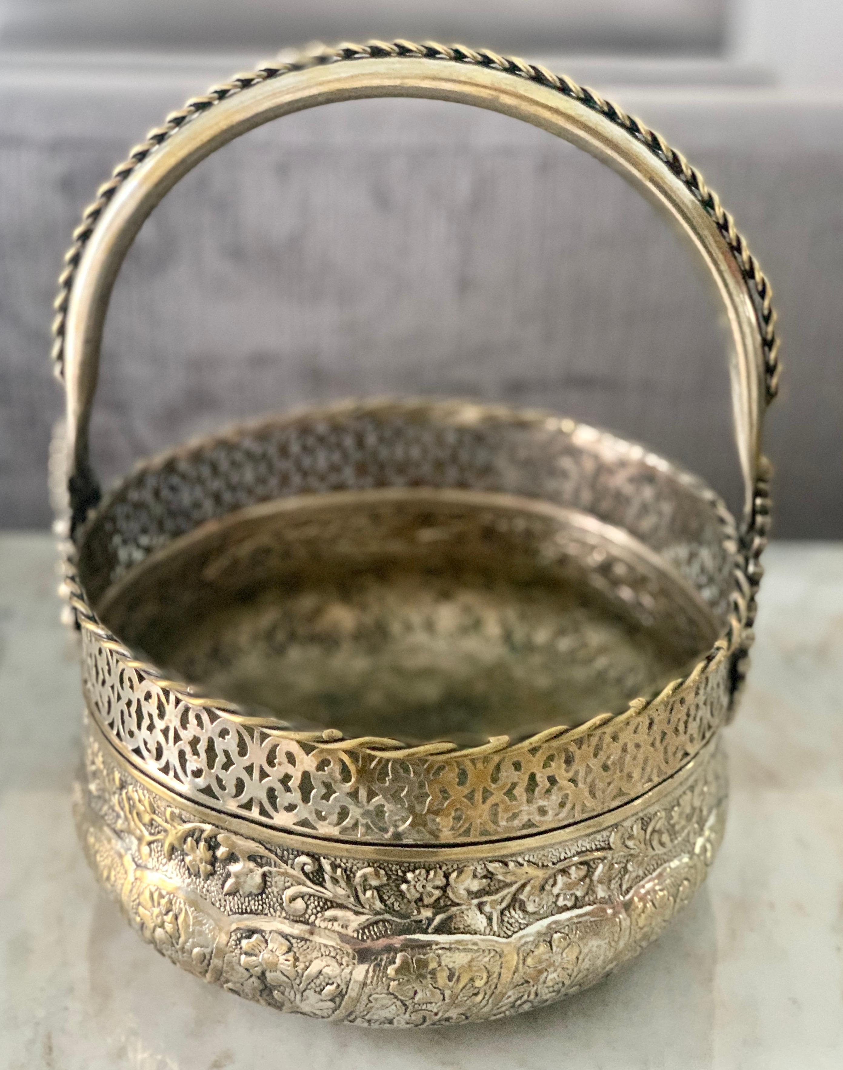 A striking silver basket with repousse and pierced lattice like detailing - hammered bottom with repousse flowers, leaves and foliage- suitable for flowers or fruit as a centerpiece. ...useful as a piece to carry items from room to room or garden to