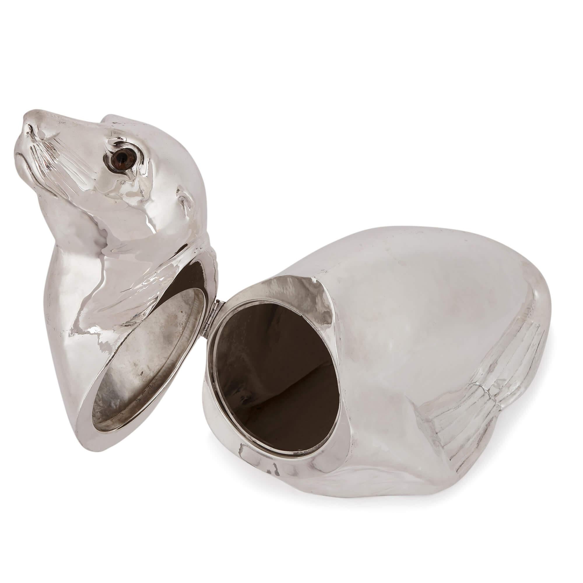 This stylish modern wine cooler is a charming piece of luxury barware, carefully sculpted in the form of a sea lion and finished in silver. The sea lion is modelled in a sitting pose, with its head pointed slightly up. Its eyes are finished in
