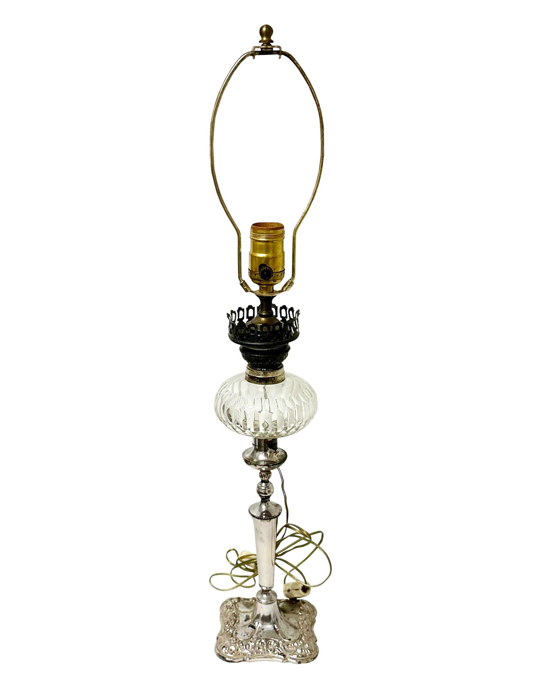 A beautiful silver plate and crystal English oil lamp, electrified.  It is in very good condition and does work also has a click switch. The silver has a floral design, no marks on the silver. Circa 1880s.