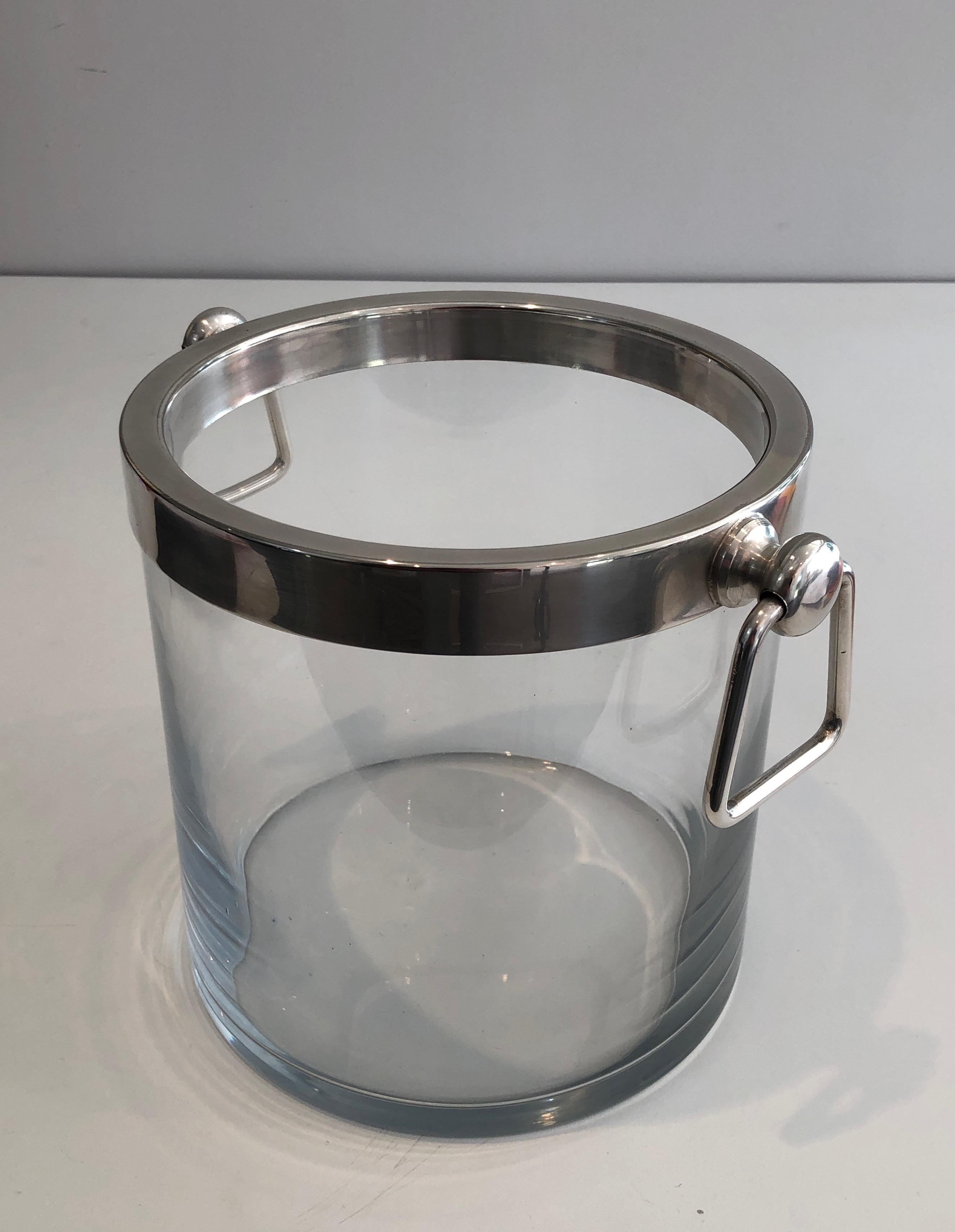This nice champagne bucket is made of glass and silver plated. This is a French work, circa 1970.
     