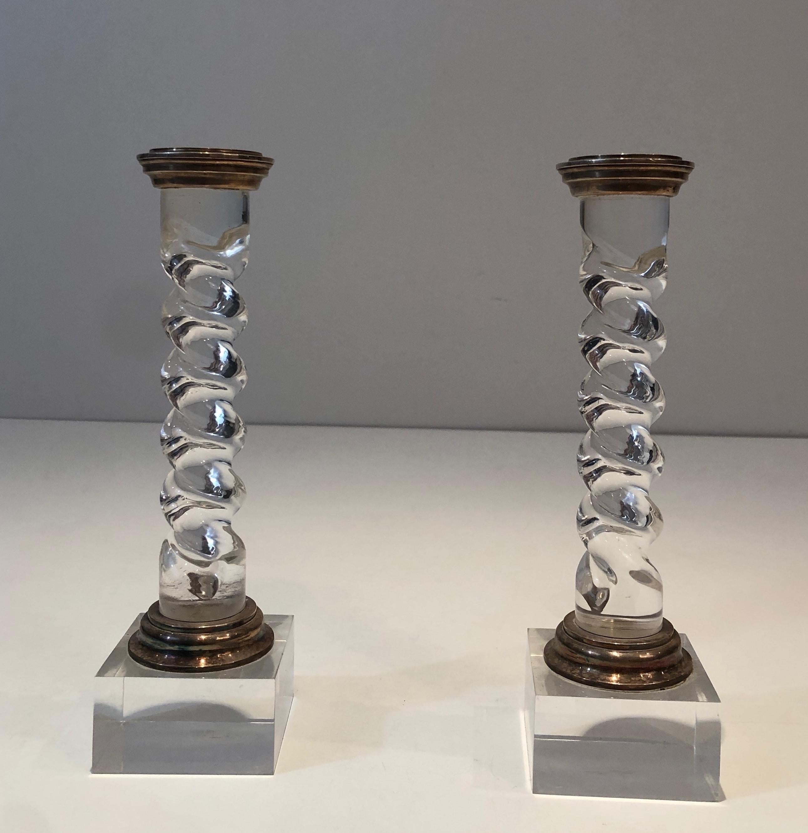 This pair of twisted candlesticks is made of lucite and silver plated. This is a French work, circa 1970.